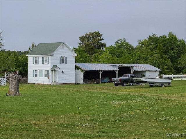 view of front of property with entry steps, a front yard, and fence