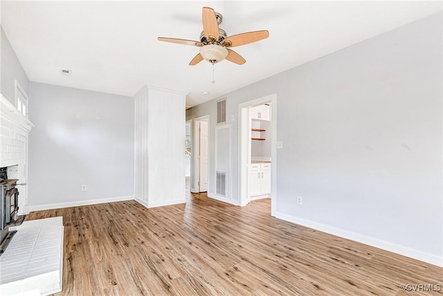 unfurnished living room featuring visible vents, a ceiling fan, light wood-style flooring, and baseboards