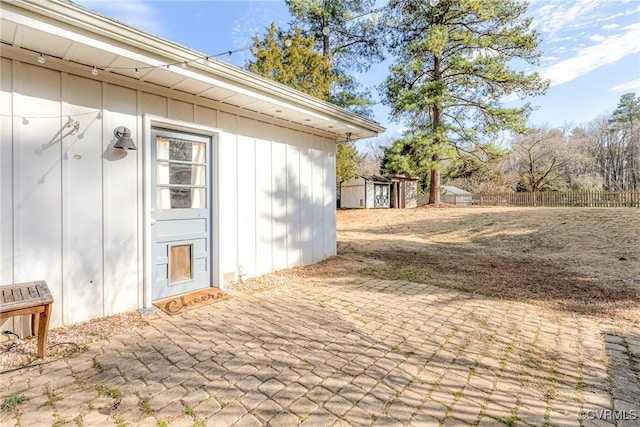 exterior space with a patio, board and batten siding, and fence