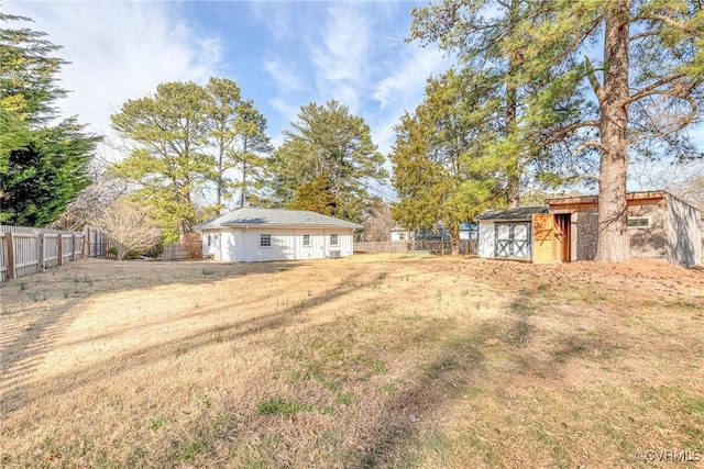 view of yard with a fenced backyard and an outdoor structure