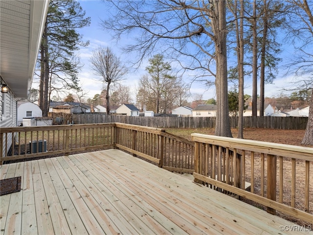 wooden terrace with cooling unit, a fenced backyard, and a residential view