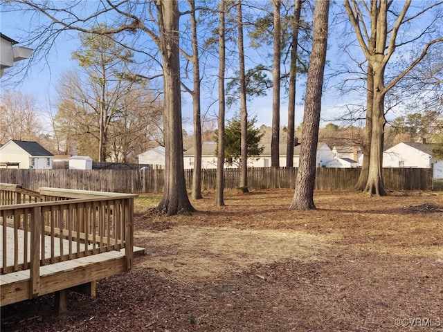 view of yard featuring a deck and fence