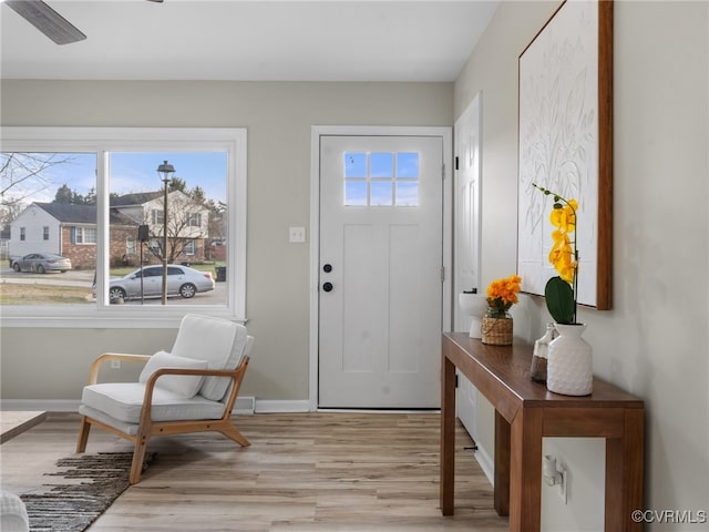 entrance foyer with baseboards and light wood finished floors