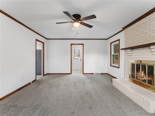 unfurnished living room with a fireplace, baseboards, carpet floors, and ornamental molding