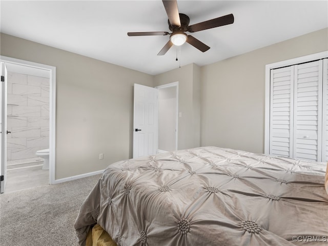 bedroom featuring a ceiling fan, baseboards, carpet floors, a closet, and ensuite bathroom