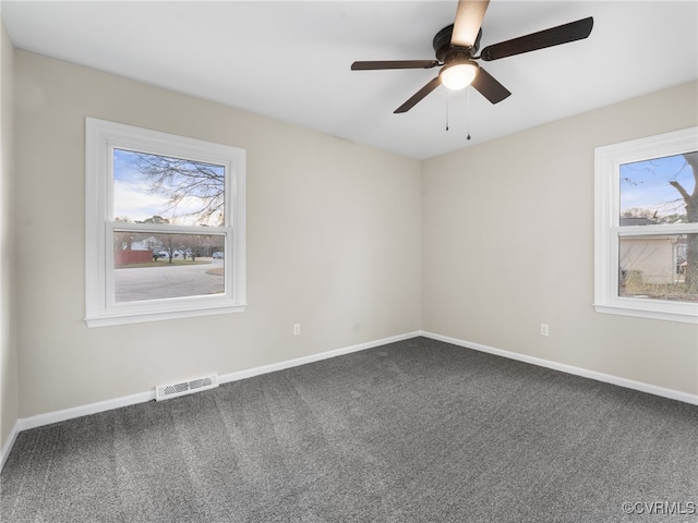 spare room featuring visible vents, carpet flooring, baseboards, and ceiling fan