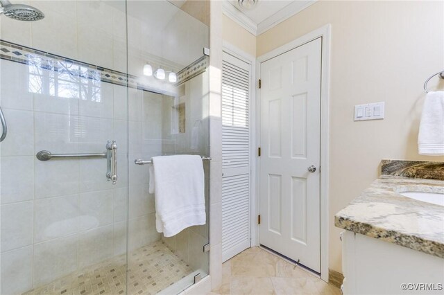 full bathroom with crown molding, a shower stall, and vanity