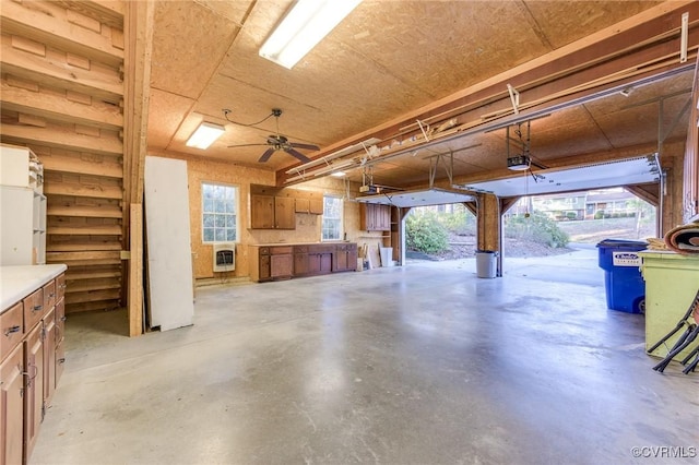 garage featuring heating unit, a ceiling fan, and a garage door opener