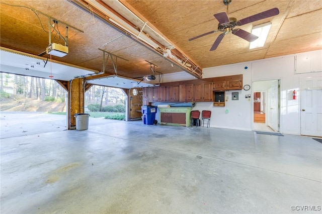 garage with electric panel and a garage door opener