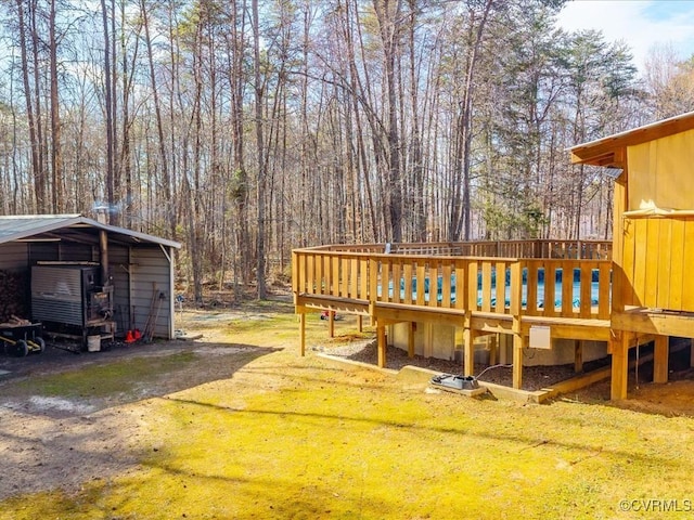 exterior space with a detached carport, driveway, and a lawn