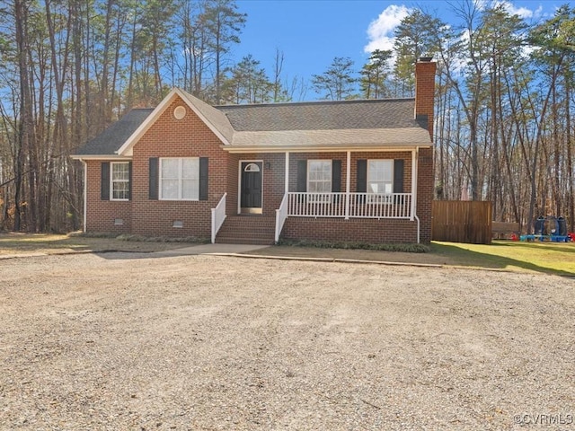 ranch-style house featuring covered porch, a shingled roof, brick siding, crawl space, and a chimney