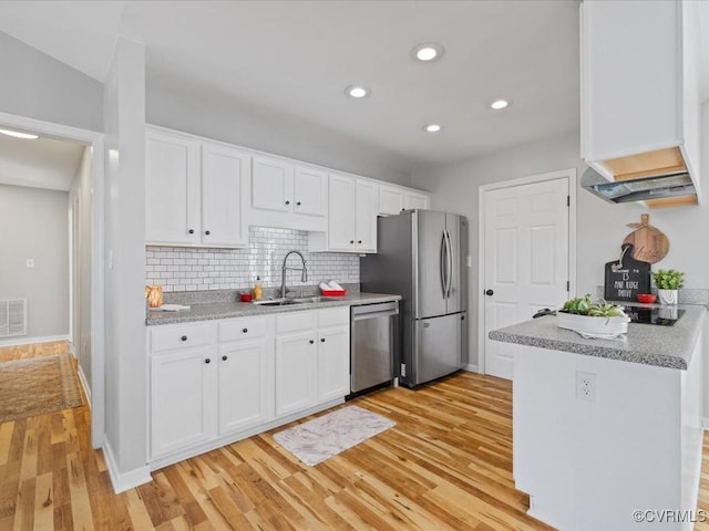 kitchen featuring stainless steel appliances, white cabinetry, a sink, and light wood finished floors