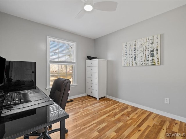 office featuring light wood-type flooring, ceiling fan, and baseboards