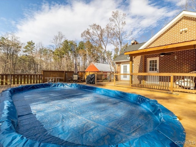 view of swimming pool featuring a fenced in pool and a deck