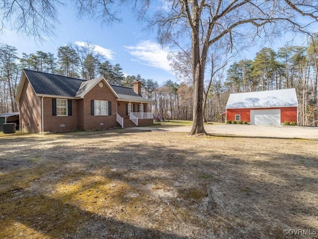 view of front of home featuring brick siding, a detached garage, a chimney, central AC unit, and crawl space