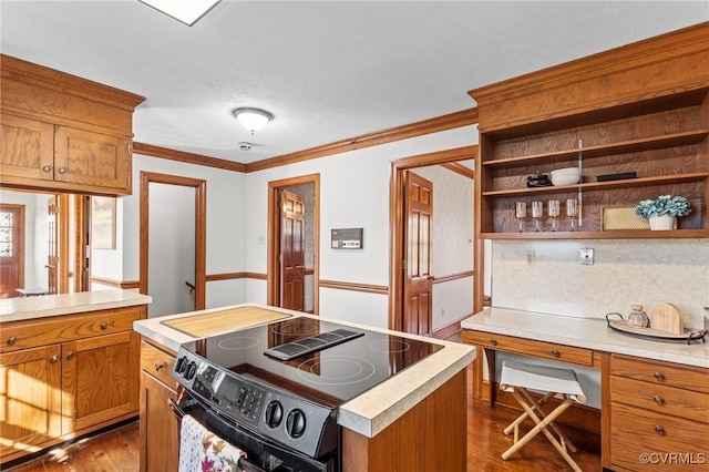 kitchen with black range with electric cooktop, dark wood finished floors, open shelves, and light countertops