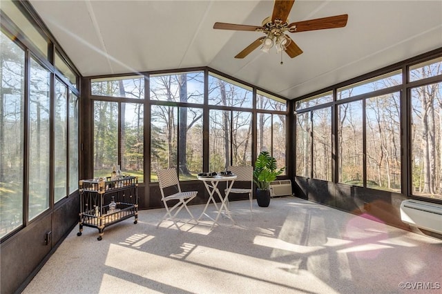 sunroom with ceiling fan, vaulted ceiling, and a wall mounted AC