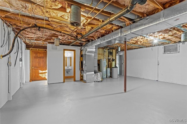 unfinished basement with electric water heater and heating unit