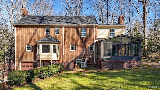 rear view of house with brick siding, a chimney, and a sunroom