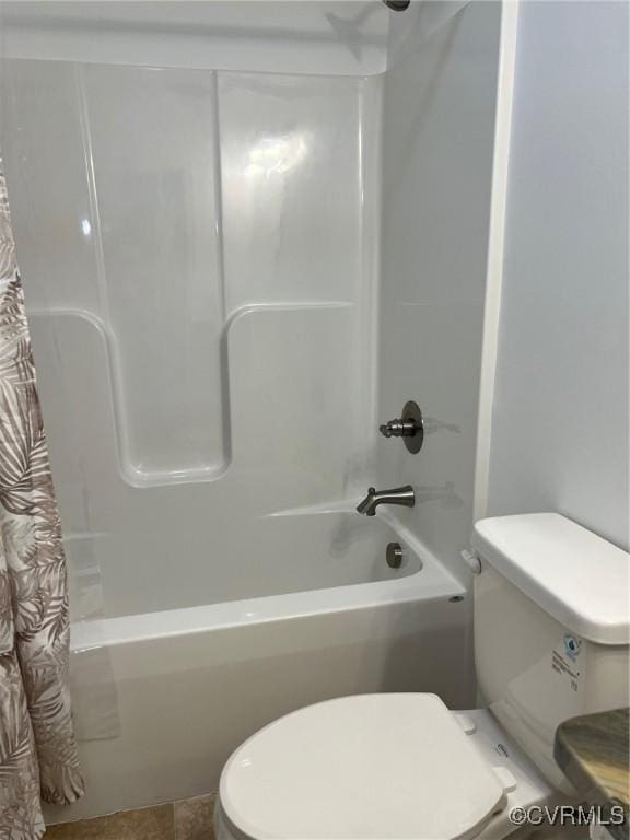 bathroom with shower / tub combo and toilet