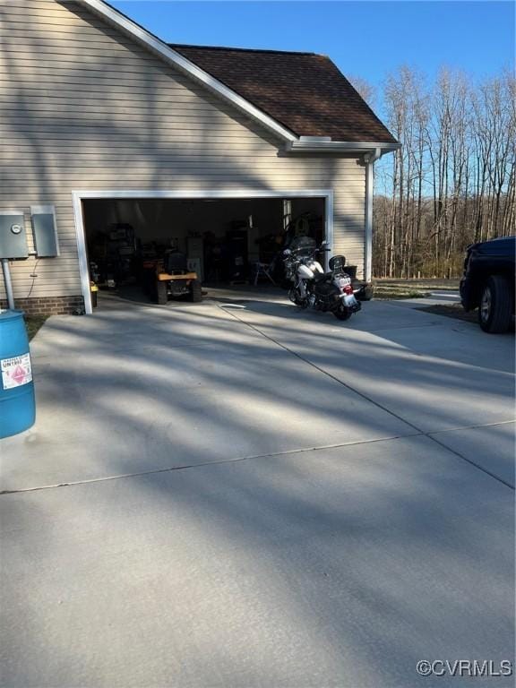 view of side of home with concrete driveway