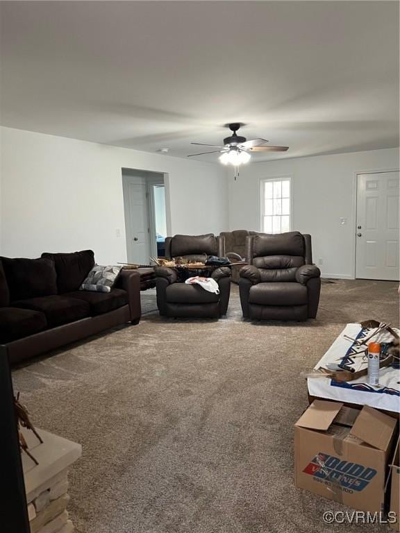 living area featuring carpet flooring and ceiling fan