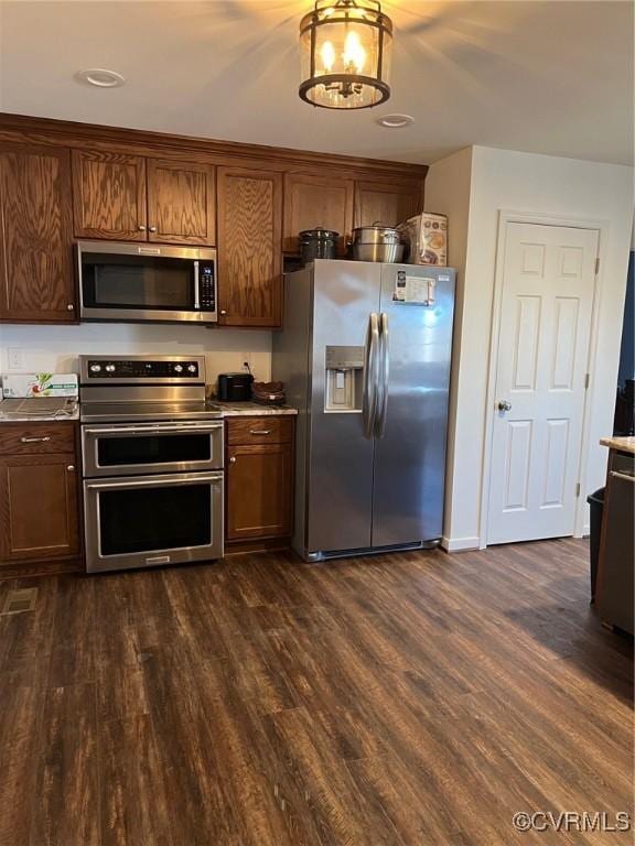 kitchen featuring appliances with stainless steel finishes and dark wood finished floors