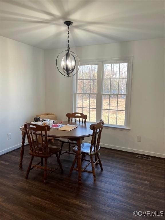 dining space with dark wood finished floors, visible vents, baseboards, and a chandelier