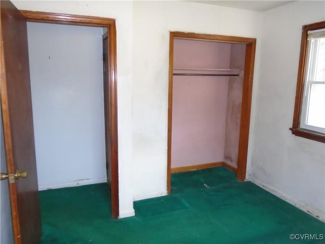 unfurnished bedroom with baseboards and a closet