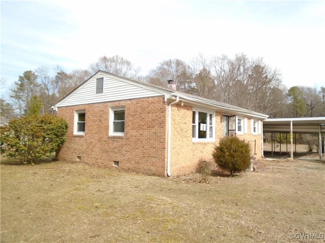 view of side of home featuring crawl space and brick siding