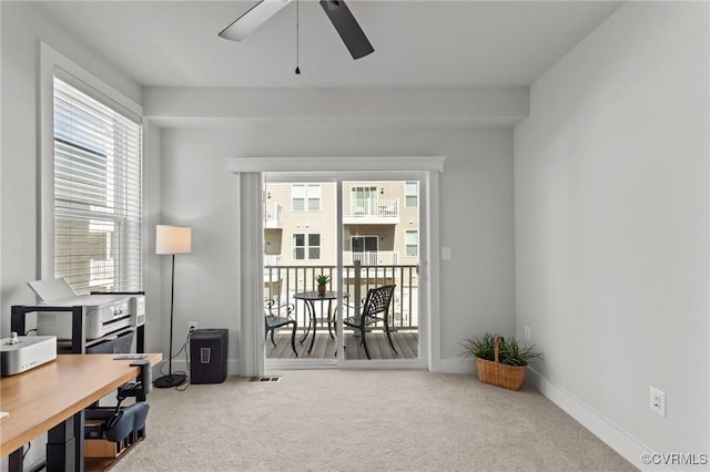 carpeted office with a ceiling fan, visible vents, and baseboards