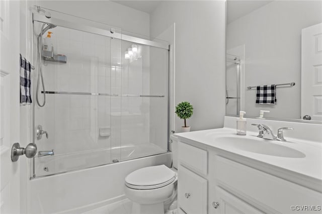 bathroom featuring toilet, bath / shower combo with glass door, and vanity