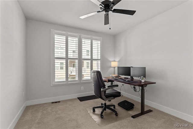 office area featuring carpet floors, baseboards, and a ceiling fan