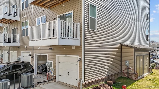 view of side of home featuring a garage and central air condition unit