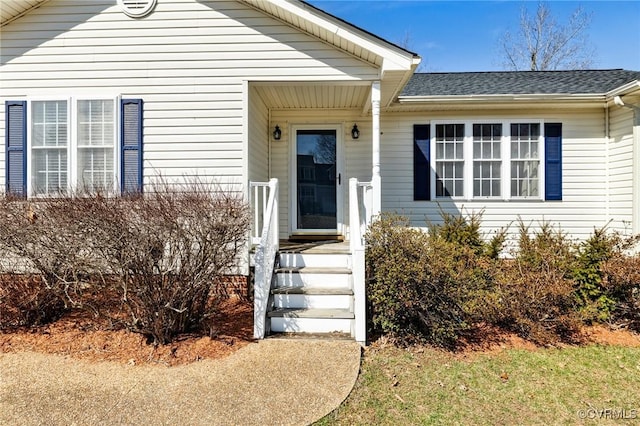 entrance to property with roof with shingles