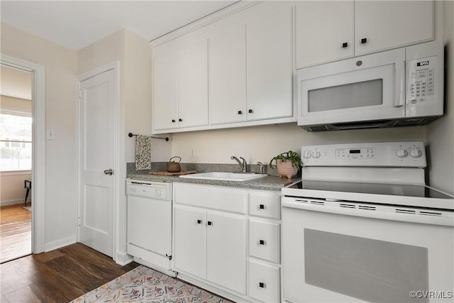 kitchen with white appliances, baseboards, dark wood-style flooring, white cabinetry, and a sink