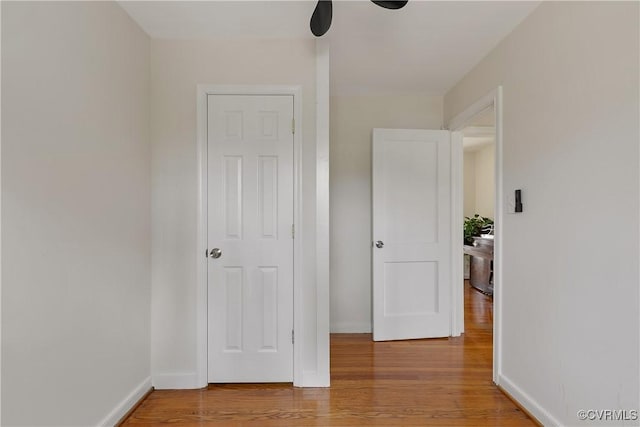 unfurnished bedroom featuring baseboards and wood finished floors