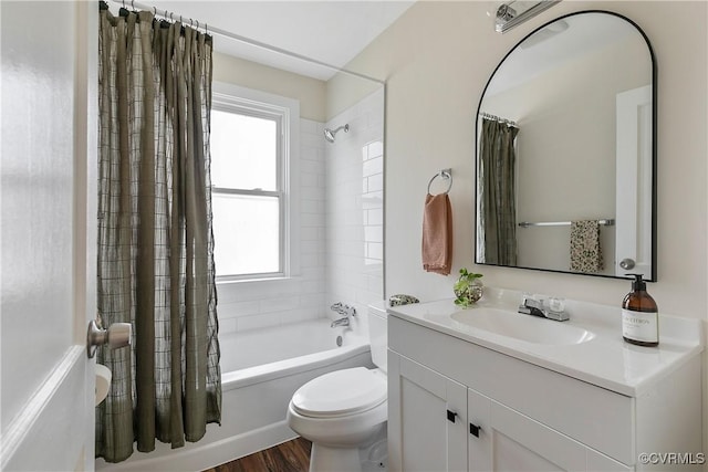 bathroom with a healthy amount of sunlight, shower / tub combo, toilet, and vanity