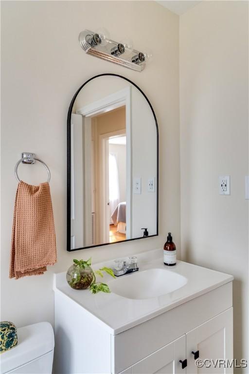 bathroom featuring toilet and vanity