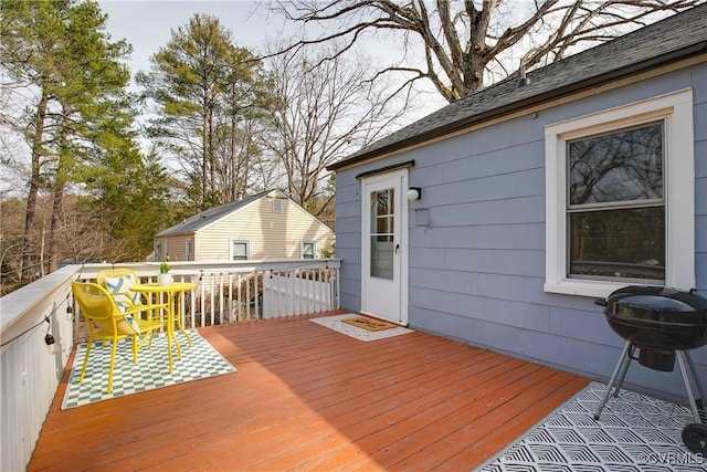 wooden terrace featuring a grill