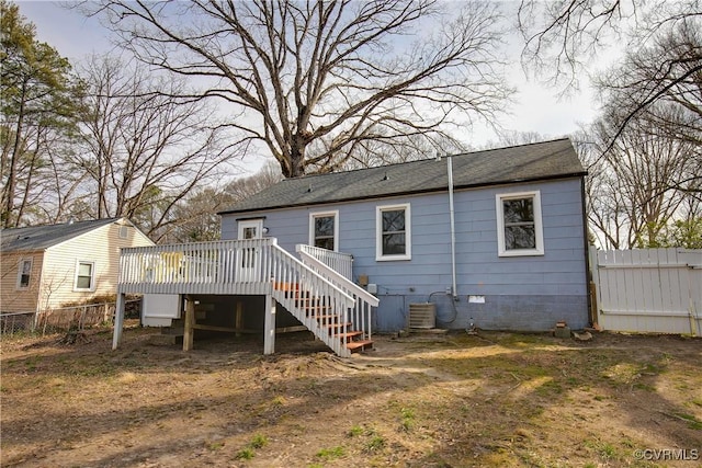 rear view of property with crawl space, stairs, fence, and a deck