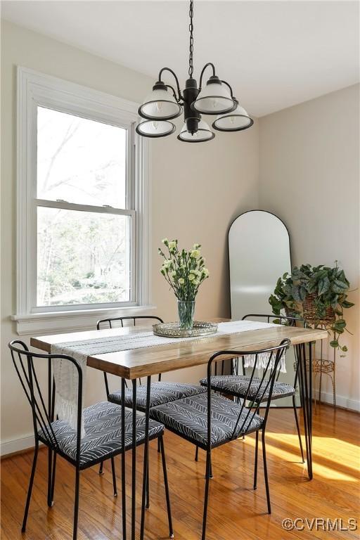 dining area featuring a wealth of natural light, baseboards, and light wood finished floors