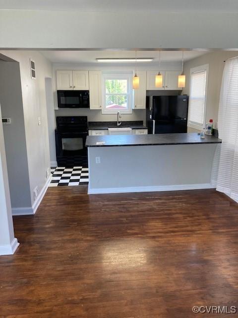 kitchen featuring white cabinetry, black appliances, dark countertops, and dark wood-type flooring