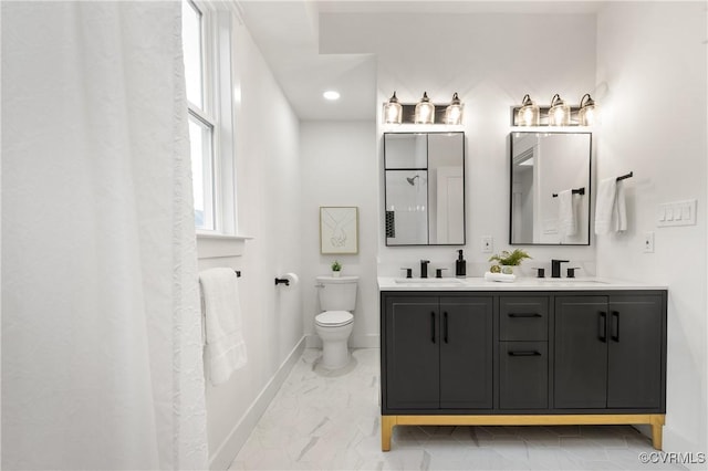 bathroom featuring double vanity, baseboards, toilet, marble finish floor, and a sink