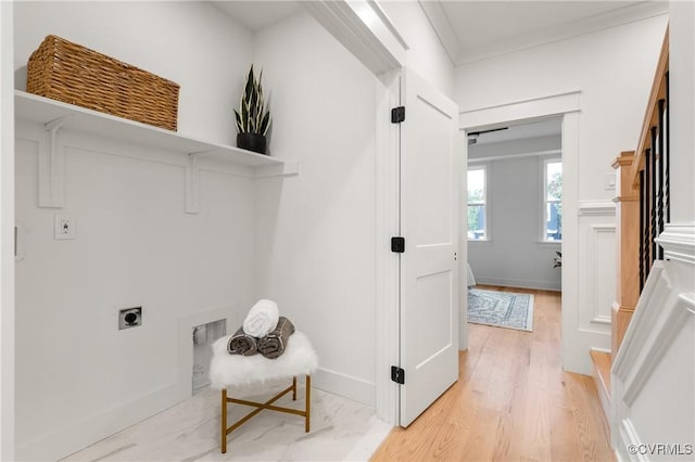 laundry room featuring laundry area, baseboards, ornamental molding, light wood-type flooring, and electric dryer hookup