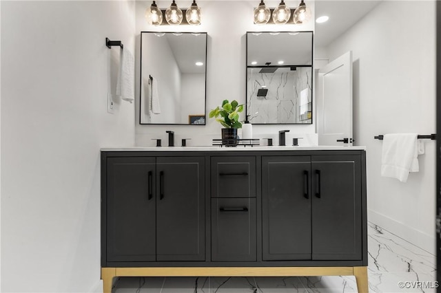 full bath featuring double vanity, a marble finish shower, baseboards, marble finish floor, and a sink