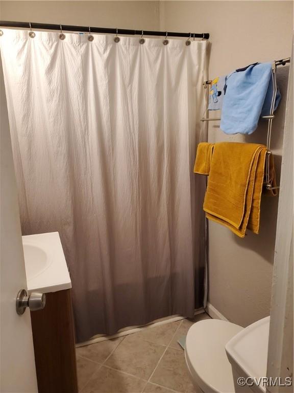 bathroom with vanity, tile patterned floors, toilet, and a shower with shower curtain