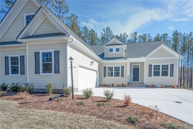 view of front of house with driveway, an attached garage, and roof with shingles