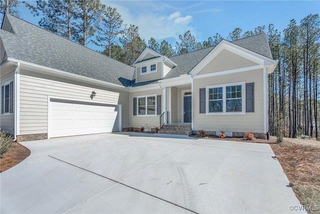 view of front of property featuring roof with shingles, driveway, and an attached garage