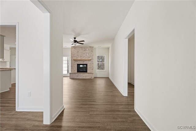 11777 Pine Needles Dr, New Kent, VA 23140 - unfurnished living room with a ceiling fan, dark wood finished floors, a large fireplace, and baseboards